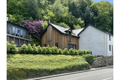 a house on the side of a road next to a house at Penestaer in Machynlleth