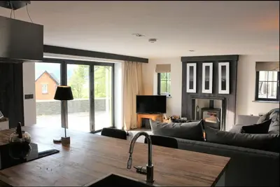 a living room with a couch and a table at Penestaer in Machynlleth