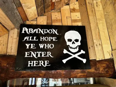 a sign that says abandon all hope ye who enter here at Coed Y Ddraig - themed 3 bedroom cottage, with bar & pool table in Tregaron