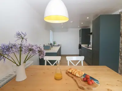 a kitchen with a table with a plate of food on it at Yr Ysgubor in Dyffryn