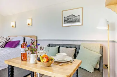 a living room with a table with fruit on it at 1 Bed in Llangadfan oc-c27292 in Llangadfan