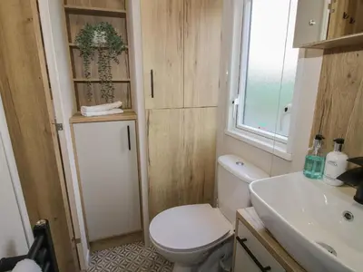 a bathroom with a toilet and a sink at Heron in Leominster