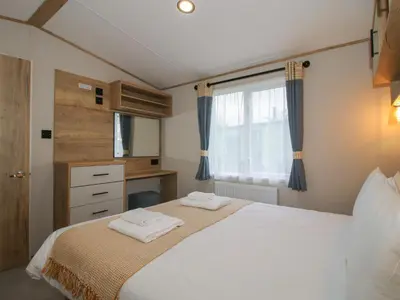 a bedroom with a bed with two towels on it at Heron in Leominster