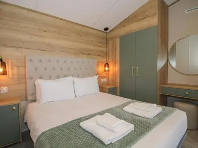 a bedroom with a bed with two towels on it at Owl in Leominster
