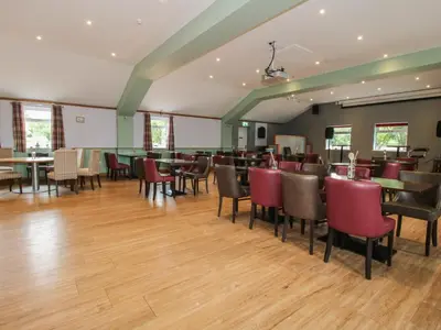 a restaurant with tables and chairs in a room at Owl in Leominster