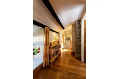 a hallway of a home with wooden floors at River Cottage Brecon: Hot Tub, Fire, Balcony, Wifi in Brecon
