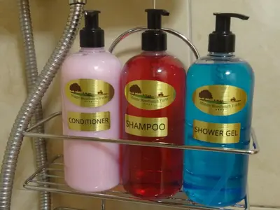 three bottles of detergent sitting on a rack at Middle Woodbatch B&B in Bishops Castle