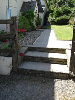 a set of stairs leading up to a house at Middle Woodbatch B&B in Bishops Castle