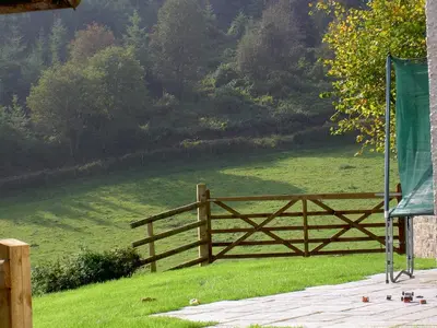 a wooden fence with a field in the background at Middle Woodbatch B&B in Bishops Castle