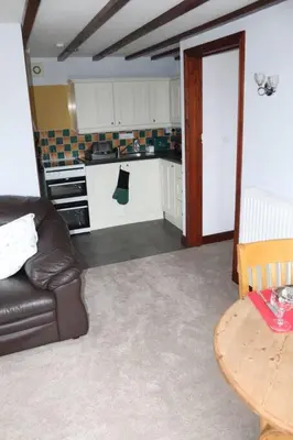 a kitchen with a couch and a table in a room at Garn Lodge in Newtown
