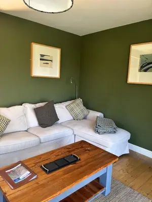 a living room with a white couch and a table at Erw Fair in Arthog