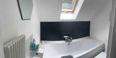 a bathroom with a sink and a bath tub at Erw Fair in Arthog