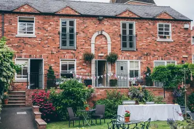 a brick house with a table in front of it at Darwins Townhouse in Shrewsbury