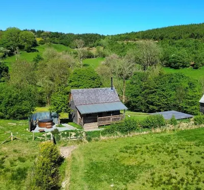 an aerial view of a house in a field at Woolly Wood Cabins - Bryn in Llandrindod Wells