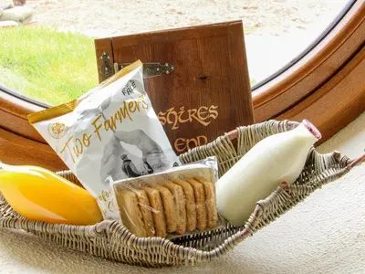 a basket of food sitting on a window sill at Shire's End in Caynham