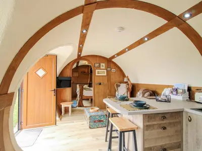 a kitchen with a large archway in a room at Shire's End in Caynham