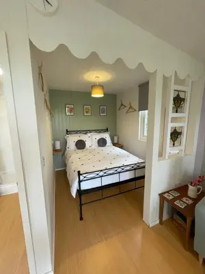 a bedroom with a bed with a cloud ceiling at Pwllglas Bach - Spacious Cabin in Machynlleth