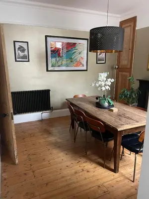 a dining room with a wooden table and chairs at Rhianfa 4 bedroom house minutes walk from the beach in New Quay
