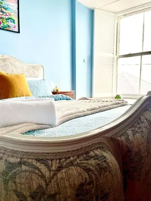 a large bed in a room with a window at Rhianfa 4 bedroom house minutes walk from the beach in New Quay