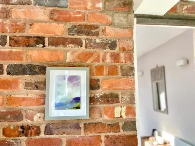 a picture hanging on a brick wall at The Old Stables, The River Severn, Shrewsbury in Shrewsbury