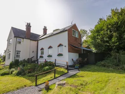 a house with a garden in front of it at 3 Oaks Lodge in Shrewsbury