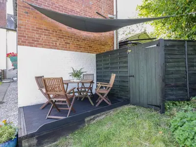 a patio with a table and chairs and a fence at 3 Oaks Lodge in Shrewsbury
