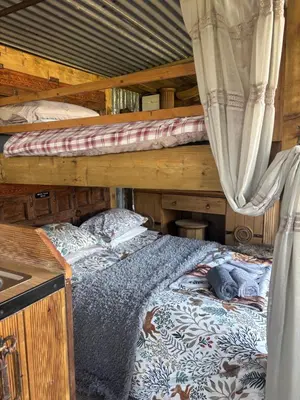 a bedroom with two bunk beds in a house at Bridie -rose with wood tub country retreat in Kington