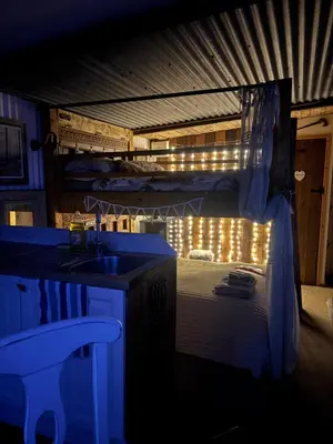 a bathroom with a sink and a bunk bed with lights at Bridie -rose with wood tub country retreat in Kington