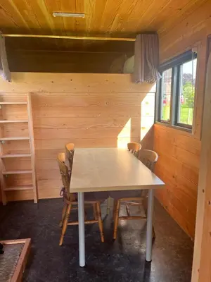 a dining room with a table and chairs in a cabin at Ox Box Cabin Lyonshall Kington in Hereford