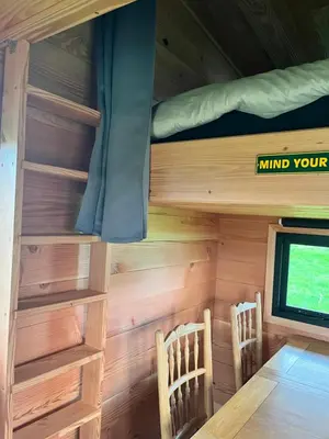 two chairs and a table in a tiny house at Beaver Tail Cabin in Hereford