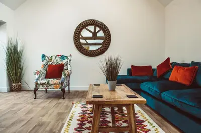 a living room with a blue couch and a table at The Granary in Montgomery