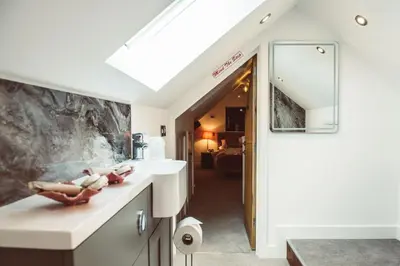 a bathroom with a sink and a mirror at The Granary in Montgomery
