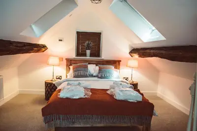 a bedroom with a large bed with two lamps at The Granary in Montgomery