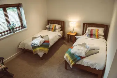 a room with two beds with towels and a window at The Clockhouse in Montgomery