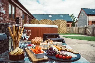 a table with a tray of food and glasses of wine at The Clockhouse in Montgomery