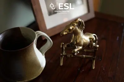 a gold miniature horse sitting on a table next to a cup at Large Country Farmhouse, Shropshire Hills View, with Hot Tub in Minsterley