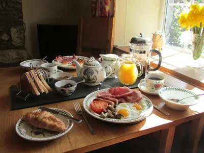 a breakfast table with breakfast foods and a breakfast gmaxwell gmaxwell gmaxwell at Bryn Sion Farm in Dinas Mawddwy