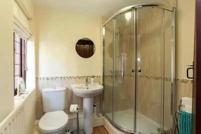 a bathroom with a shower and a toilet and a sink at 12A College Hill by Sleep Shrewsbury in Shrewsbury