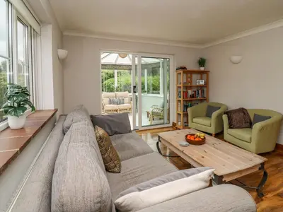 a living room with a couch and a table at Rhydygroes in Lampeter