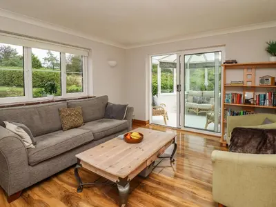 a living room with a couch and a coffee table at Rhydygroes in Lampeter