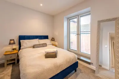 a bedroom with a large bed and a window at 5B One bedrom Central Modern Apartment - Pass the Keys in Shrewsbury