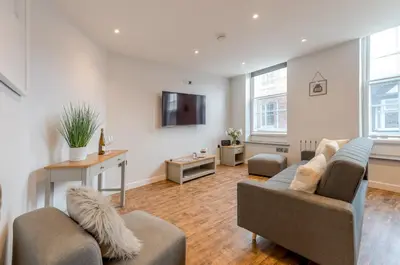 a living room with two couches and a tv at 5B One bedrom Central Modern Apartment - Pass the Keys in Shrewsbury