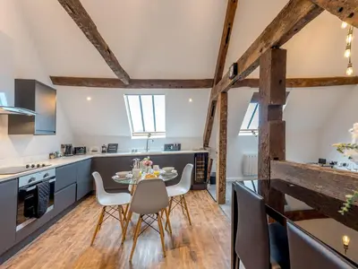 a kitchen and dining room with a table and chairs at 5C Charming Town Centre Apartment With Roof Top Views - Pass the Keys in Shrewsbury