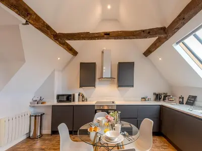 a kitchen and dining room with a table and chairs at 5C Charming Town Centre Apartment With Roof Top Views - Pass the Keys in Shrewsbury