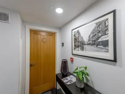a hallway with a door and a picture on the wall at 40C 2 bed Celosia Beautiful Town Centre Apartment - Pass the Keys in Shrewsbury