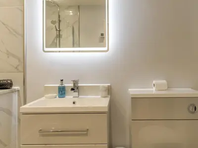 a white bathroom with a sink and a mirror at 1 bed 40C Beautiful Town Apartment Celosia - Pass the Keys in Shrewsbury