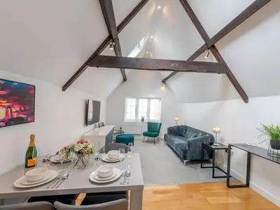 a living room with a table and a couch at 1 bed 40C Beautiful Town Apartment Celosia - Pass the Keys in Shrewsbury