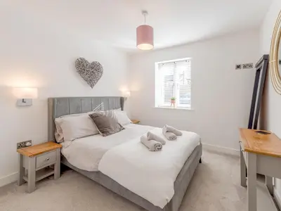a bedroom with a bed with towels on it at Contemporary Apartment with Secure Parking - Pass the Keys in Shrewsbury
