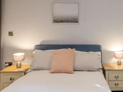 a bedroom with a bed with two lamps on tables at Amaranth Stylish town centre apartment - Pass the Keys in Shrewsbury