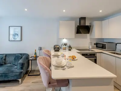 a kitchen and living room with a table and chairs at Amaranth Stylish town centre apartment - Pass the Keys in Shrewsbury